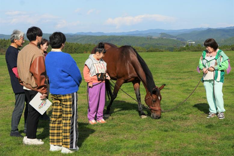 美味しそうな牧草に夢中で動かないお馬さんにビックリの村上さん・黒沢さん