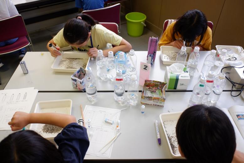 川砂を観察してマイクロプラスチックを採取する様子